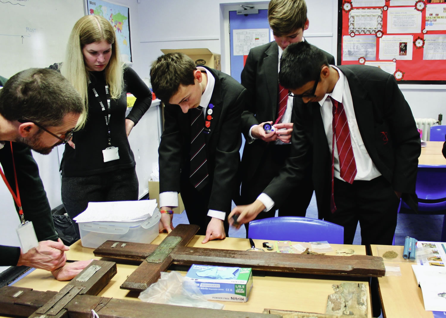 Students from Pittville School closely examining the crosses. Credit: Pittville School.